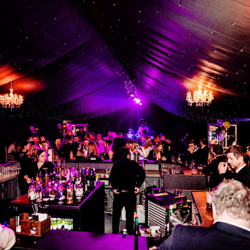 Premium Party Marquee for a private event with black star cloth, crystal chandelier